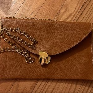 Brown crossbody bag with gold chain.